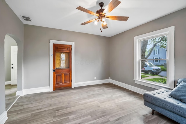 229 Pennsylvania Ave, Marion, OH 43302 - unfurnished room featuring arched walkways, baseboards, a ceiling fan, and wood finished floors