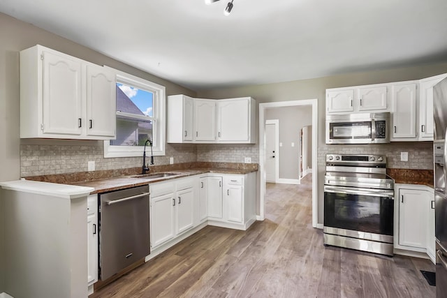 229 Pennsylvania Ave, Marion, OH 43302 - kitchen featuring stainless steel appliances, a sink, backsplash, and white cabinetry