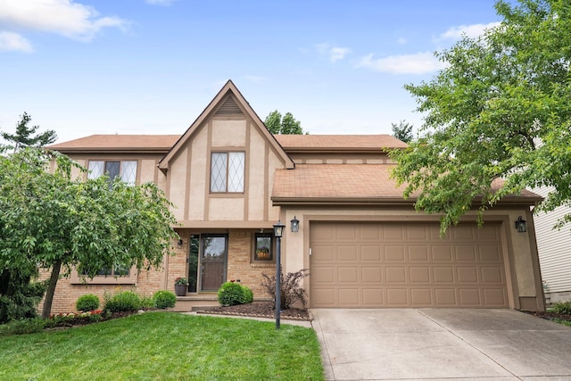 5524 Rushden Dr, Columbus, OH 43230 - tudor home with stucco siding, concrete driveway, a front yard, a garage, and brick siding