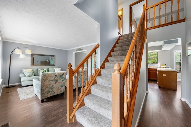 5524 Rushden Dr, Columbus, OH 43230 - stairway featuring wood-type flooring, a textured ceiling, and crown molding