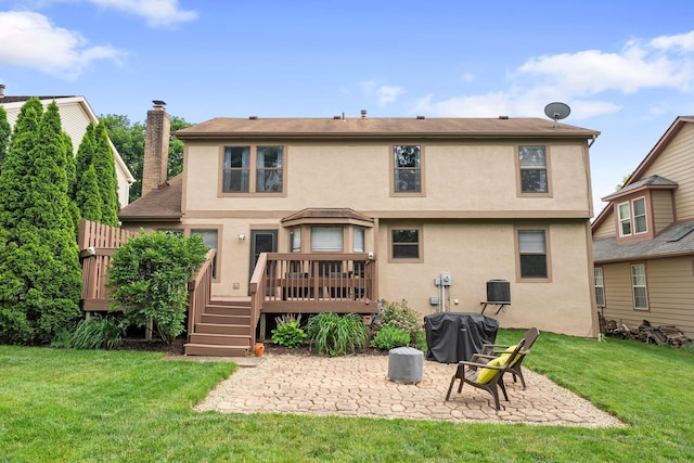 5524 Rushden Dr, Columbus, OH 43230 - back of property with a patio, stucco siding, a wooden deck, a lawn, and a chimney