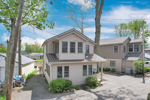 view of front of home with cooling unit and metal roof