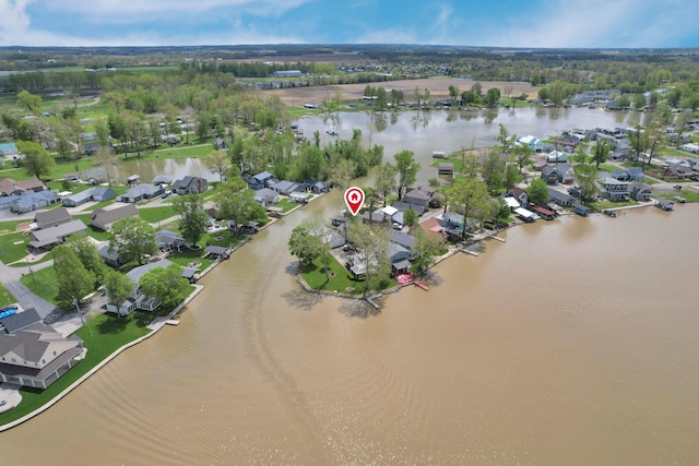 aerial overview of property's location with a nearby body of water and nearby suburban area
