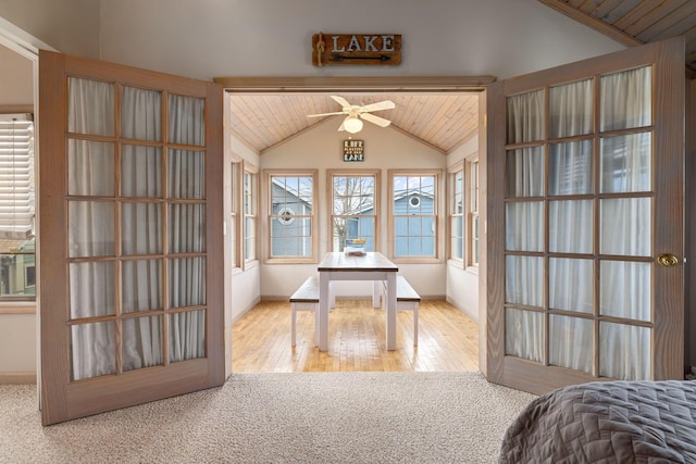 bedroom featuring vaulted ceiling, carpet, baseboards, wooden ceiling, and wood finished floors