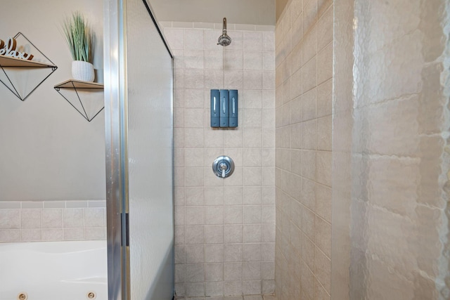 bathroom featuring a tile shower and a whirlpool tub