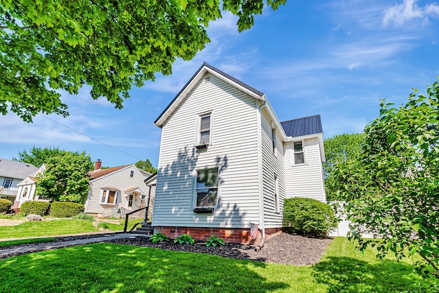 76 Resch St, Kenton, OH 43326 - view of side of property featuring a yard and metal roof