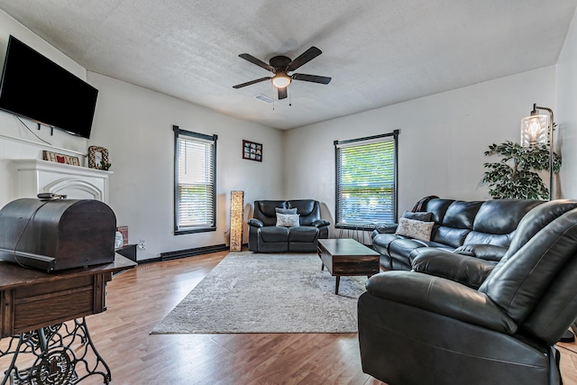 76 Resch St, Kenton, OH 43326 - living area featuring plenty of natural light, wood finished floors, ceiling fan, and a textured ceiling