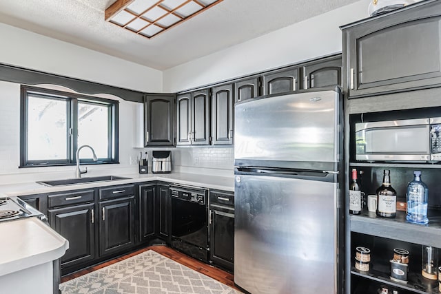 76 Resch St, Kenton, OH 43326 - kitchen with stainless steel appliances, a sink, dark wood-style flooring, light countertops, and dark cabinets