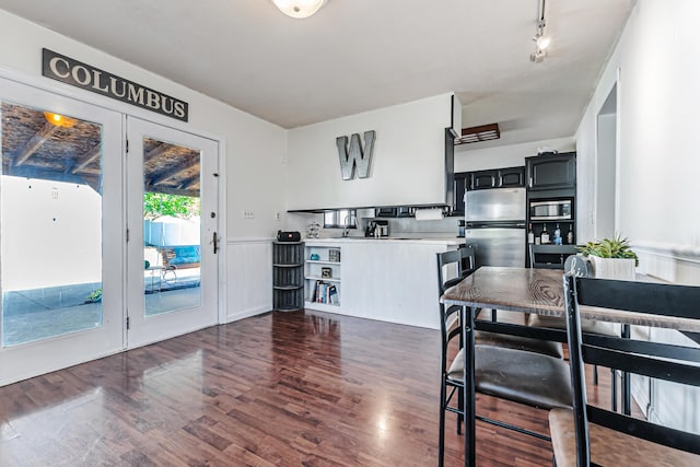 76 Resch St, Kenton, OH 43326 - kitchen with stainless steel appliances, light countertops, dark wood-style flooring, dark cabinets, and a wainscoted wall
