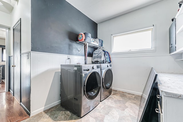 76 Resch St, Kenton, OH 43326 - laundry room featuring washer and dryer, cabinet space, and stone finish floors