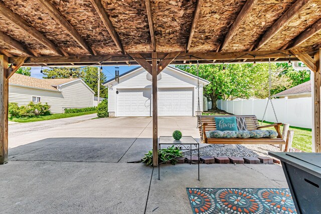 76 Resch St, Kenton, OH 43326 - view of patio featuring an outbuilding, a detached garage, and fence