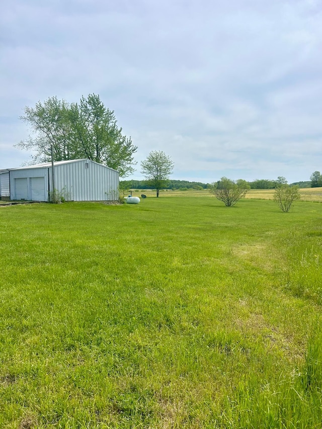 3617 Waugh Rd, Frankfort, OH 45628 - view of grassy yard featuring a detached garage, a pole building, and an outbuilding