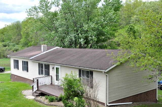 6051 E Clinton St, Albany, OH 45710 - back of property with a wooden deck, a lawn, roof with shingles, and a chimney