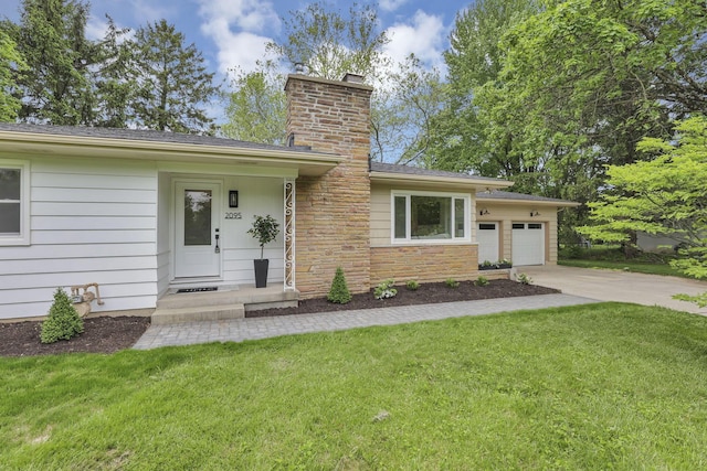 2095 Mccoy Rd, Upper Arlington, OH 43220 - view of front of home with driveway, a chimney, a garage, and a front lawn