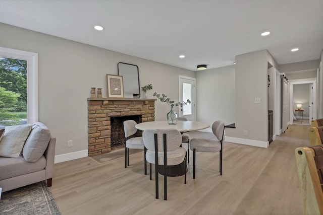 2095 Mccoy Rd, Upper Arlington, OH 43220 - dining room featuring light wood finished floors, baseboards, a stone fireplace, and recessed lighting