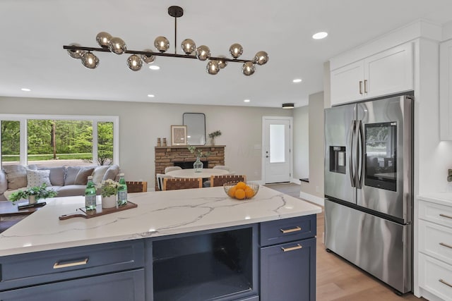 2095 Mccoy Rd, Upper Arlington, OH 43220 - kitchen featuring stainless steel fridge with ice dispenser, open floor plan, white cabinets, blue cabinetry, and recessed lighting