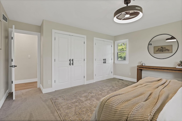 2095 Mccoy Rd, Upper Arlington, OH 43220 - carpeted bedroom featuring multiple closets and baseboards