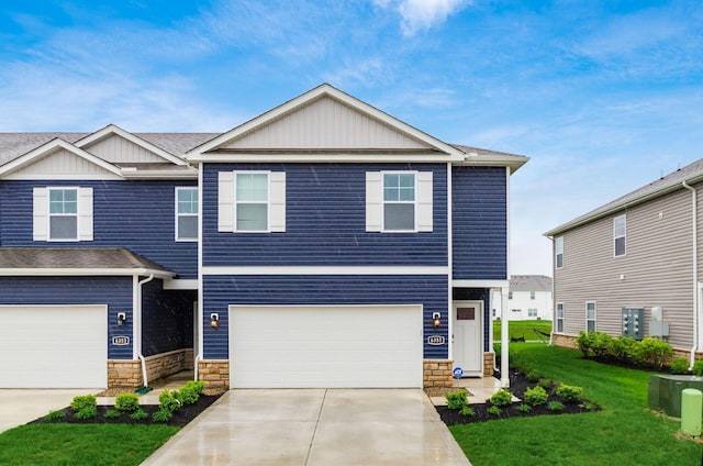 6355 Marinelli Dr N, Columbus, OH 43228 - view of front of house with an attached garage, concrete driveway, a front yard, stone siding, and board and batten siding