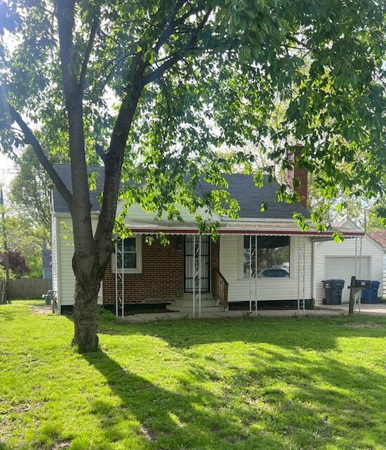 985 S Yearling Rd, Columbus, OH 43227 - rear view of house with an attached garage and a chimney