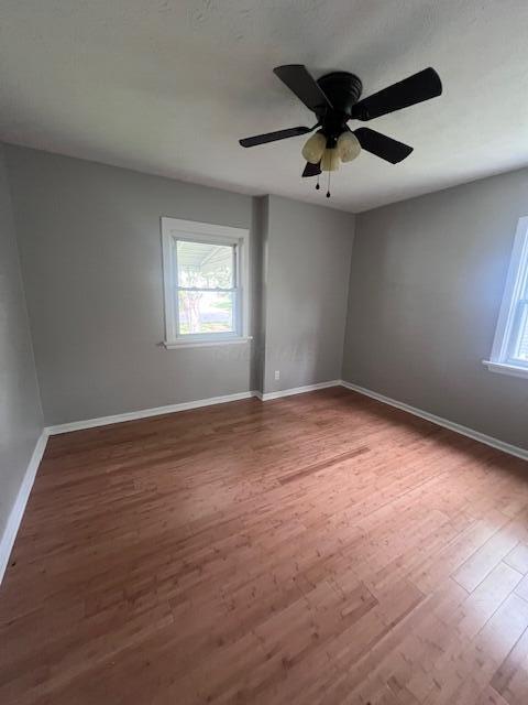 985 S Yearling Rd, Columbus, OH 43227 - unfurnished room featuring healthy amount of natural light, wood finished floors, and baseboards
