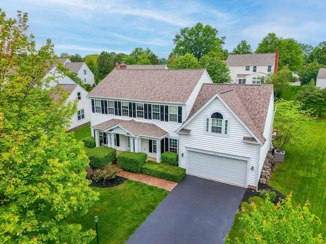 5073 Thornwood Dr, Westerville, OH 43082 - view of front of home with driveway, a garage, roof with shingles, central AC, and a front lawn