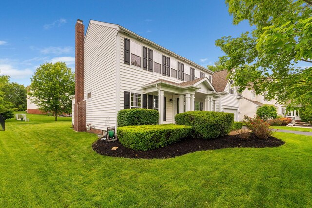 5073 Thornwood Dr, Westerville, OH 43082 - view of front facade with a chimney, a front yard, and a garage