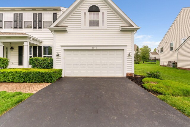 5073 Thornwood Dr, Westerville, OH 43082 - view of front of home with driveway, a front lawn, and a garage