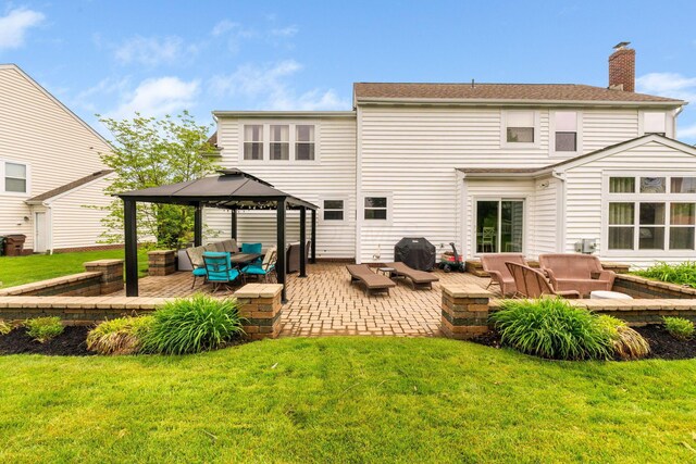 5073 Thornwood Dr, Westerville, OH 43082 - back of house with outdoor lounge area, a gazebo, a lawn, and a chimney