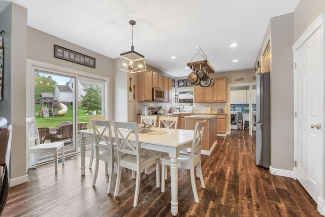 5073 Thornwood Dr, Westerville, OH 43082 - dining space with separate washer and dryer, dark wood-style flooring, baseboards, a chandelier, and recessed lighting