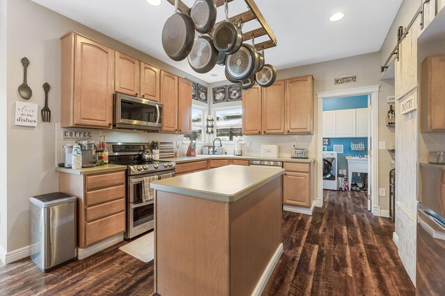 5073 Thornwood Dr, Westerville, OH 43082 - kitchen with appliances with stainless steel finishes, dark wood finished floors, a sink, recessed lighting, and light countertops