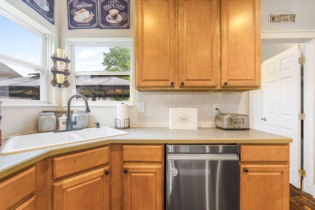 5073 Thornwood Dr, Westerville, OH 43082 - kitchen featuring stainless steel dishwasher, a sink, healthy amount of natural light, and decorative backsplash