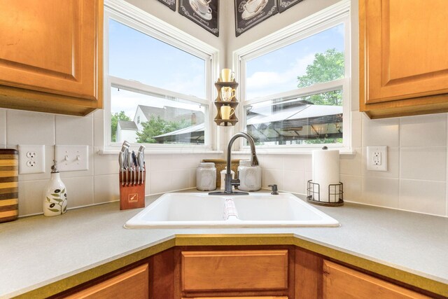 5073 Thornwood Dr, Westerville, OH 43082 - kitchen view of a sink, tasteful backsplash, light countertops, and brown cabinets