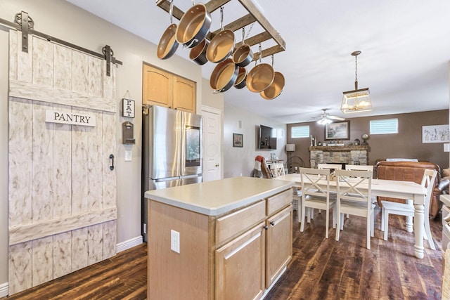 5073 Thornwood Dr, Westerville, OH 43082 - kitchen with light brown cabinetry, ceiling fan, dark wood finished floors, stainless steel fridge with ice dispenser, and a barn door