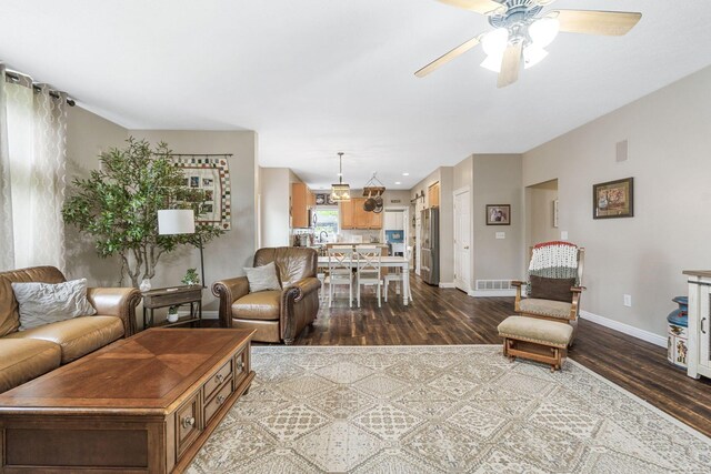 5073 Thornwood Dr, Westerville, OH 43082 - living area with dark wood finished floors, ceiling fan, and baseboards