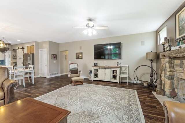 5073 Thornwood Dr, Westerville, OH 43082 - living area featuring dark wood finished floors, baseboards, ceiling fan, and a barn door