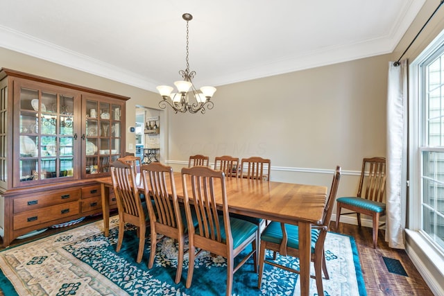 5073 Thornwood Dr, Westerville, OH 43082 - dining space with a chandelier, ornamental molding, wood finished floors, and baseboards