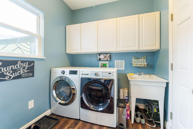 5073 Thornwood Dr, Westerville, OH 43082 - washroom featuring cabinet space, washer and clothes dryer, dark wood-style floors, and baseboards
