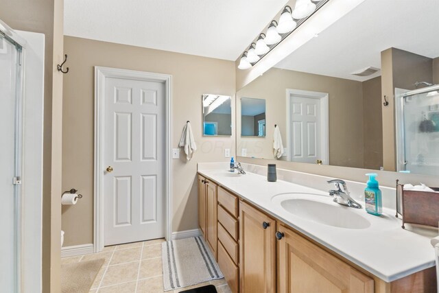 5073 Thornwood Dr, Westerville, OH 43082 - bathroom with double vanity, a stall shower, baseboards, and tile patterned floors