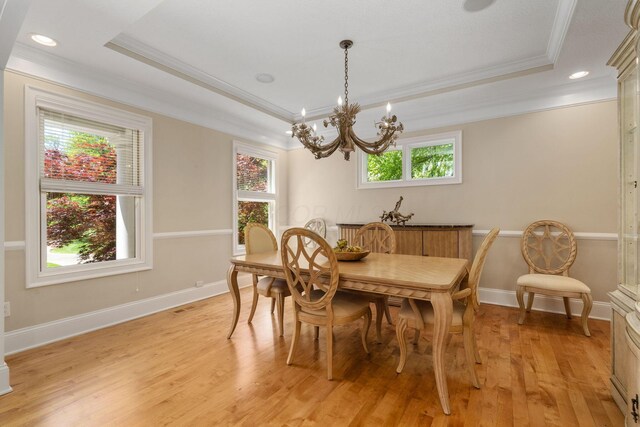 504 W Orange Rd, Delaware, OH 43015 - dining room with crown molding, light wood-style floors, a raised ceiling, a chandelier, and baseboards