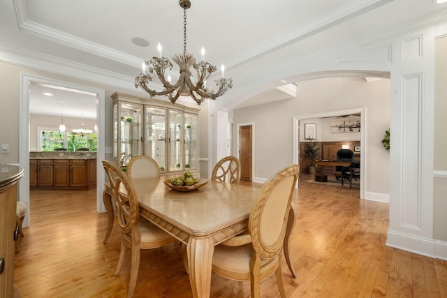 504 W Orange Rd, Delaware, OH 43015 - dining area with a chandelier, arched walkways, light wood finished floors, an office area, and crown molding