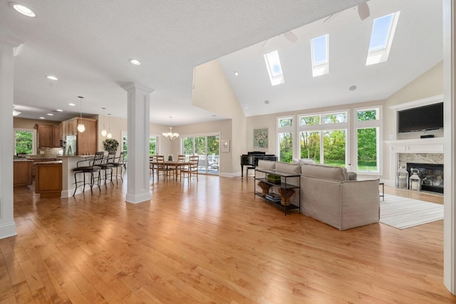 504 W Orange Rd, Delaware, OH 43015 - living room with light wood-style floors, a glass covered fireplace, a skylight, recessed lighting, and high vaulted ceiling