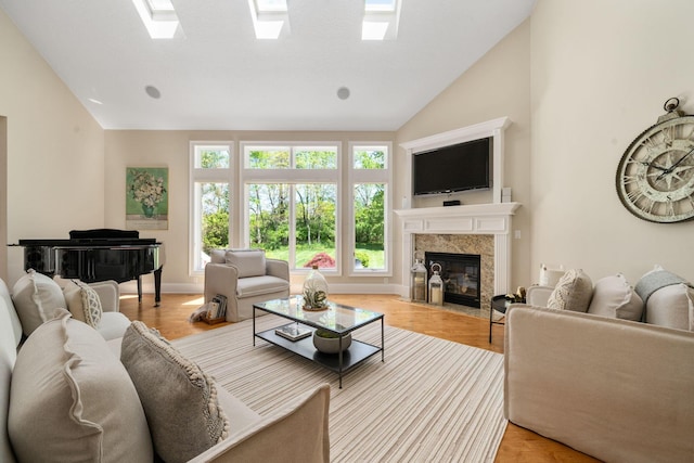 504 W Orange Rd, Delaware, OH 43015 - living room featuring a high end fireplace, light wood-style floors, a skylight, and high vaulted ceiling