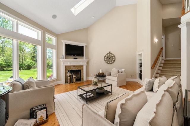 504 W Orange Rd, Delaware, OH 43015 - living room with high vaulted ceiling, a premium fireplace, stairs, a skylight, and baseboards