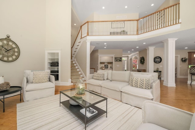504 W Orange Rd, Delaware, OH 43015 - living area with stairs, a high ceiling, recessed lighting, decorative columns, and baseboards