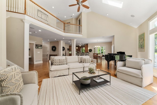 504 W Orange Rd, Delaware, OH 43015 - living area featuring high vaulted ceiling, wood finished floors, decorative columns, a ceiling fan, and a chandelier
