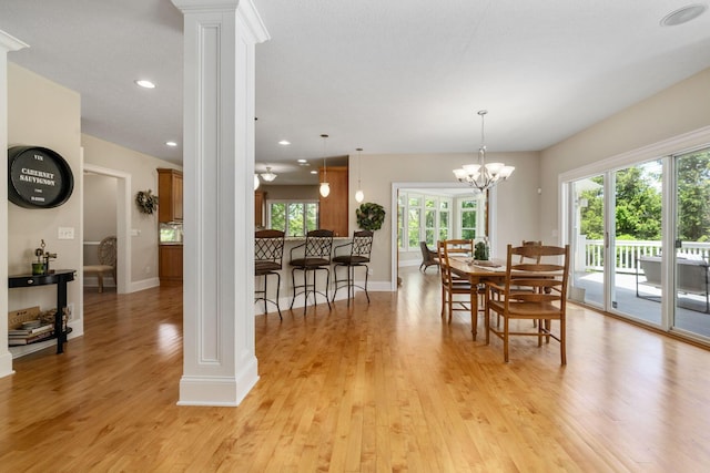 504 W Orange Rd, Delaware, OH 43015 - dining space featuring ornate columns, light wood finished floors, baseboards, recessed lighting, and a chandelier
