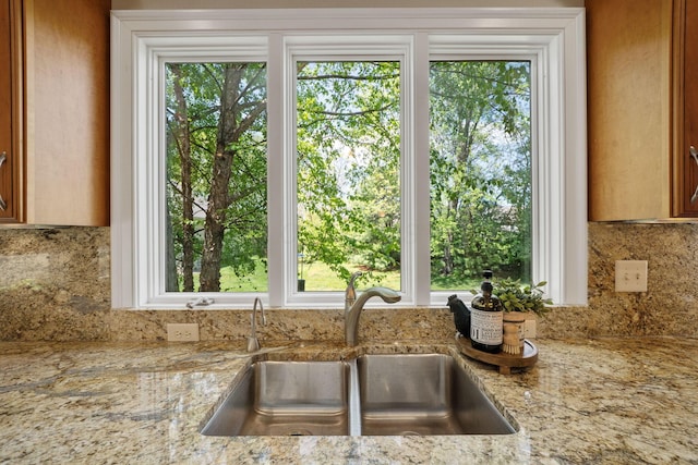 504 W Orange Rd, Delaware, OH 43015 - kitchen view of a sink, backsplash, and light stone counters