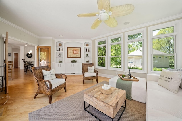 504 W Orange Rd, Delaware, OH 43015 - living area with healthy amount of natural light, a ceiling fan, ornamental molding, built in shelves, and light wood-style flooring