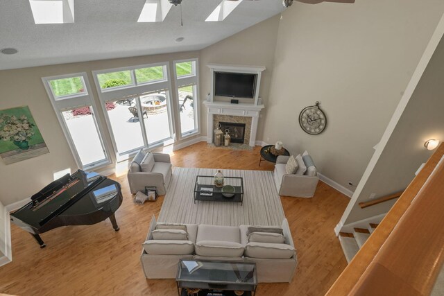 504 W Orange Rd, Delaware, OH 43015 - living area featuring lofted ceiling, ceiling fan, a skylight, stairway, and wood finished floors