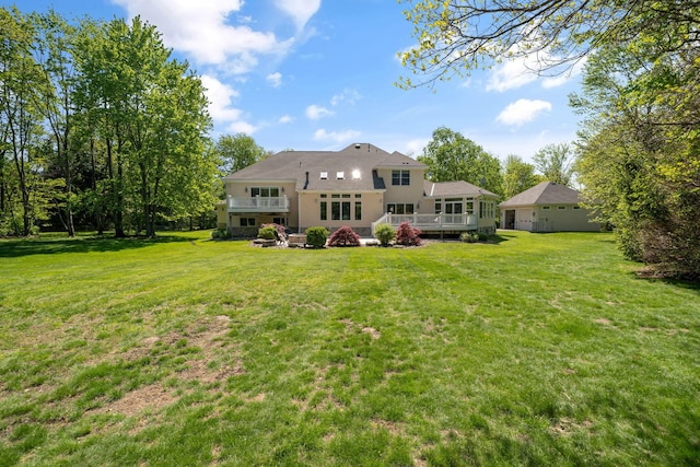 504 W Orange Rd, Delaware, OH 43015 - rear view of property featuring a lawn, a wooden deck, and stucco siding